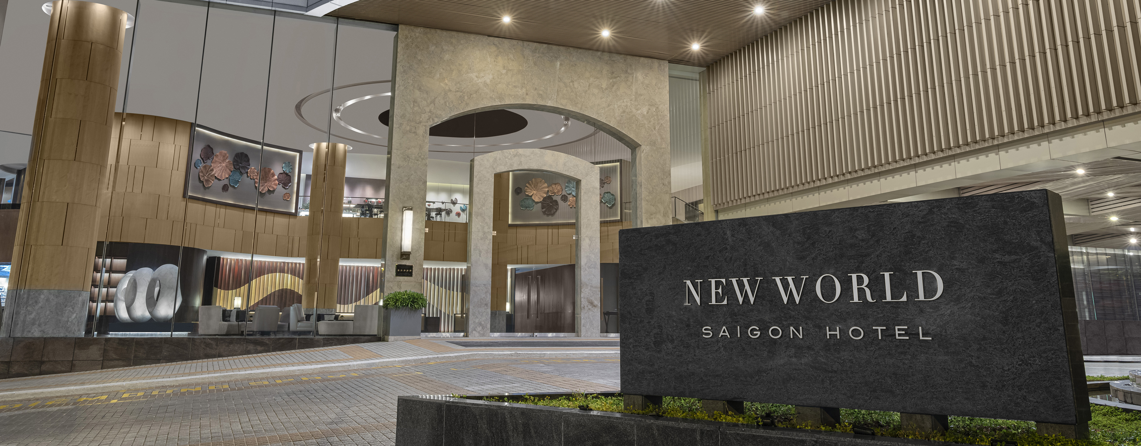 the exterior signage for the New World Saigon Hotel in Ho Chi Minh City in front of the driveway to the hotel entrance